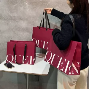 Bolsas boutique personalizadas de lujo impresas ecológicas con logo, bolsa de embalaje con logo para tienda de ropa con asa