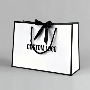 Sac cadeau de luxe personnalisé avec logo, sac en papier pour boutiques, emballage avec poignées en ruban pour vêtements